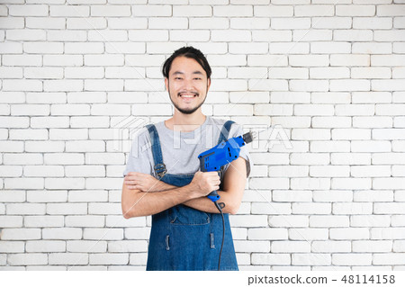 Young Asian man holding power drill 48114158