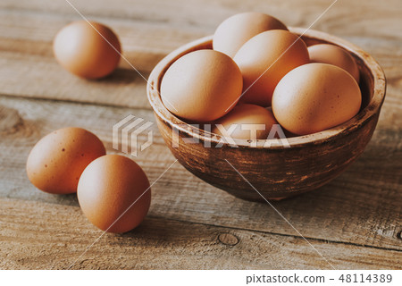 Bowl of raw chicken eggs 48114389