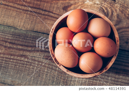 Bowl of raw chicken eggs 48114391