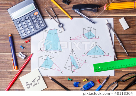 Album sheet with geometry pictures and student material on wooden table. Album sheet with geometry pictures and student material on wooden table. 48118364
