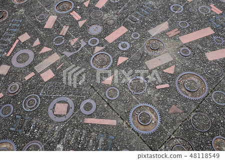 Pavement filled with gears 48118549