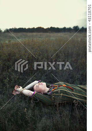 Beautiful hippie woman lying on grass relaxing 48118701