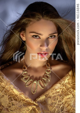 beautiful young woman with necklace in golden light beautiful young woman with necklace in golden light 48118846