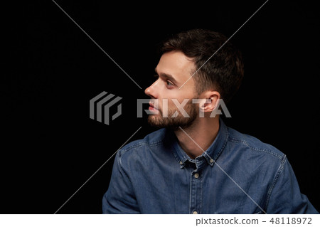 Profile of serious handsome man in denim shirt looking aside Profile of serious handsome man in denim shirt looking aside 48118972