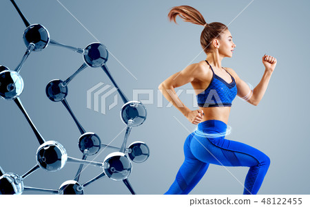 Sporty young woman runing and jumping near glass molecules. Sporty young woman runing and jumping near glass molecules. 48122455
