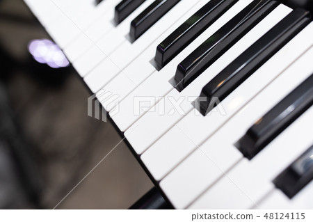 Black and white piano keys close up 48124115
