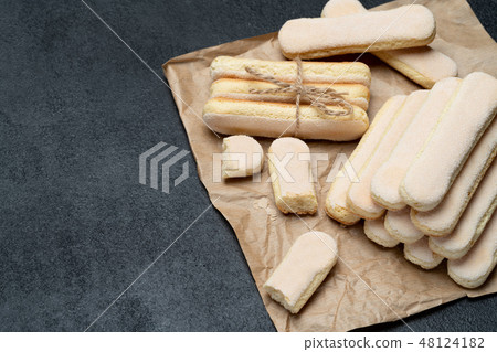 Italian Savoiardi ladyfingers Biscuits on concrete backgound 48124182