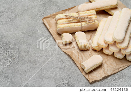 Italian Savoiardi ladyfingers Biscuits on concrete backgound 48124186
