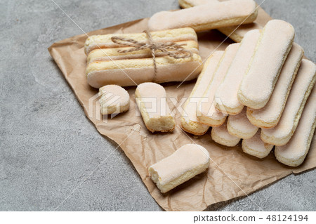 Italian Savoiardi ladyfingers Biscuits on concrete backgound Italian Savoiardi ladyfingers Biscuits on concrete backgound 48124194