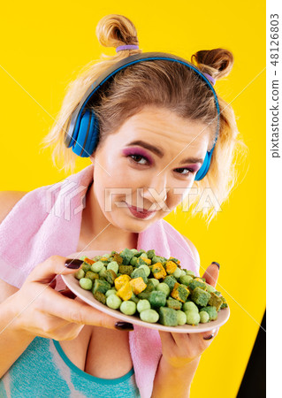 Woman losing weight not having control looking at nits and crisps Woman losing weight not having control looking at nits and crisps 48126803
