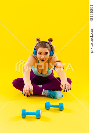 Woman loving weights feeling tired after exercising in the morning 48126891