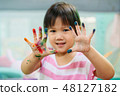 Kid painting with colorful art work 48127182
