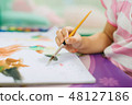 Kid painting with colorful art work 48127186