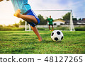 kid playing soccer football for exercise 48127265