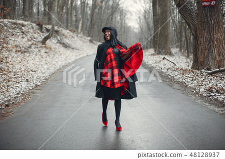 Elegant black girl in a winter park Elegant black girl in a winter park 48128937