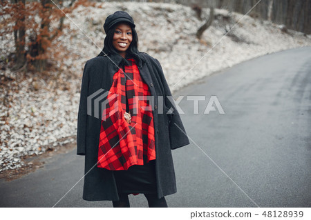 Elegant black girl in a winter park Elegant black girl in a winter park 48128939