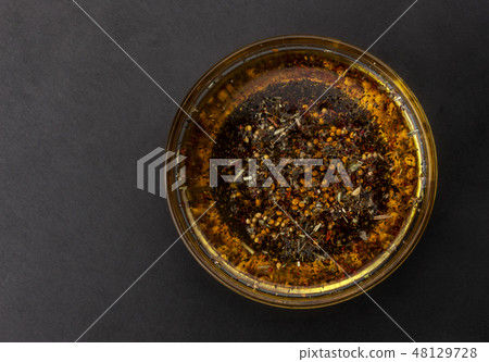 Oil salad dressing isolated on black background, top view Oil salad dressing isolated on black background, top view 48129728