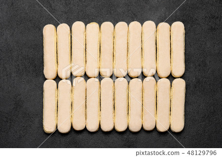 Italian Savoiardi ladyfingers Biscuits on dark concrete backgound Italian Savoiardi ladyfingers Biscuits on dark concrete backgound 48129796