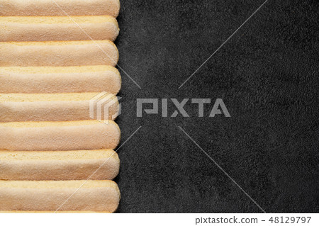 Italian Savoiardi ladyfingers Biscuits on dark concrete backgound Italian Savoiardi ladyfingers Biscuits on dark concrete backgound 48129797