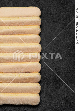 Italian Savoiardi ladyfingers Biscuits on dark concrete backgound Italian Savoiardi ladyfingers Biscuits on dark concrete backgound 48129798