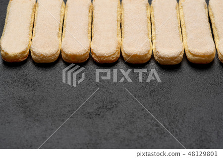 Italian Savoiardi ladyfingers Biscuits on dark concrete backgound Italian Savoiardi ladyfingers Biscuits on dark concrete backgound 48129801
