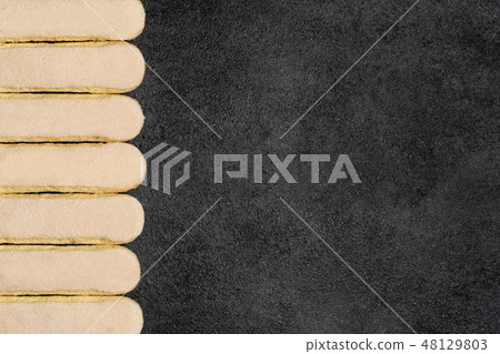 Italian Savoiardi ladyfingers Biscuits on dark concrete backgound Italian Savoiardi ladyfingers Biscuits on dark concrete backgound 48129803