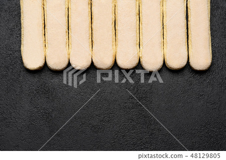 Italian Savoiardi ladyfingers Biscuits on dark concrete backgound 48129805