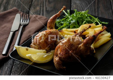 Grilled quails with fried potatoes and tomato dip. Grilled quails with fried potatoes and tomato dip. 48130427