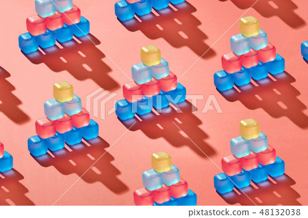 Creative pattern of pyramids from plastic colorful ice cubes on a background in a trend color of the Creative pattern of pyramids from plastic colorful ice cubes on a background in a trend color of the 48132038