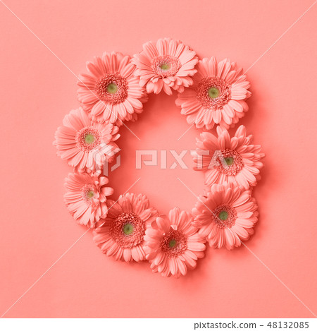 Letter O made from flowers gerbera on a color background of the year 2019 Living Coral Pantone. Part 48132085