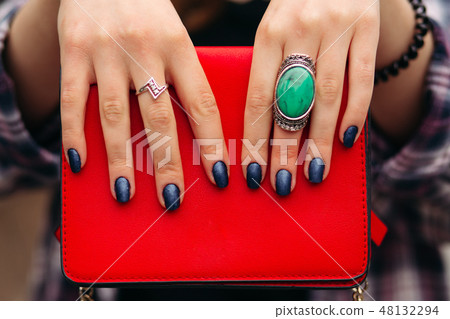 Unrecognizable woman with dark nails holding red 48132294