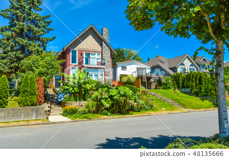 Beautiful suburban house with landscaped terraces and blue sky background Beautiful suburban house with landscaped terraces and blue sky background 48135666