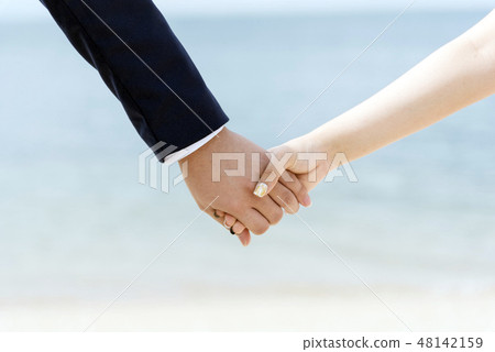 couple lover holding hands together walking beach couple lover holding hands together walking beach 48142159