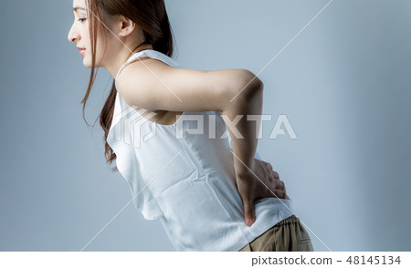 A woman with low back pain A woman with low back pain 48145134
