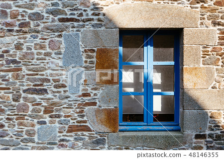 Blue window on stone wall in village in Brittany Blue window on stone wall in village in Brittany 48146355