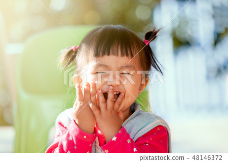 asian girl closing her face and playing peekaboo 48146372