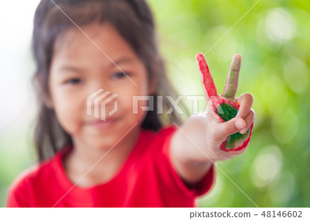 child girl with painted hands showing fingers 48146602