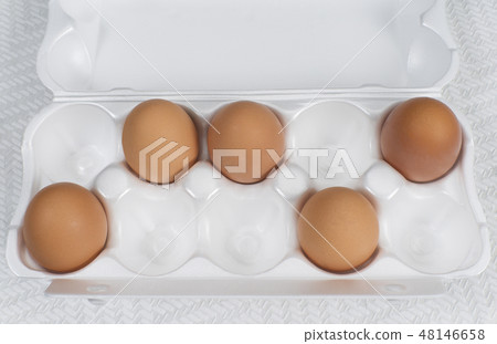 chicken eggs in a plastic container, top view 48146658