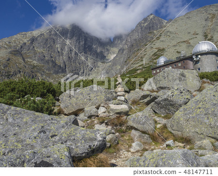 View on mountain Peak Lomnicky stit 2 634 m covered in clouds at Summer with Skalnate pleso 48147711