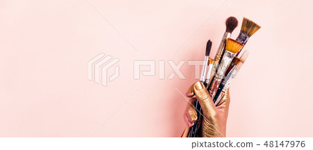 Female Artist golden hand with set of brushes. Banner format Female Artist golden hand with set of brushes. Banner format 48147976