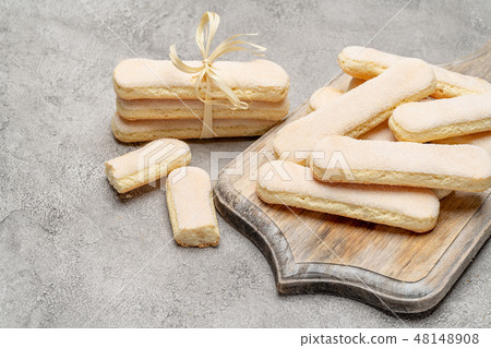 Italian Savoiardi ladyfingers Biscuits on concrete backgound Italian Savoiardi ladyfingers Biscuits on concrete backgound 48148908