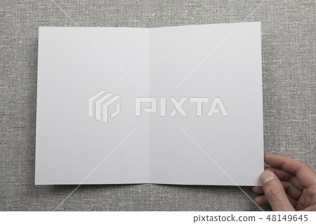 Mens hands holding empty white booklet Mens hands holding empty white booklet 48149645