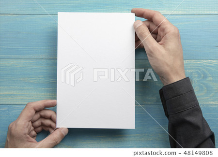Mens hands holding white letterhead Mens hands holding white letterhead 48149808