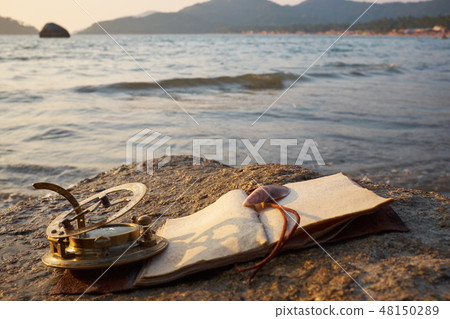 rocky beach with old vintage sundial and note rocky beach with old vintage sundial and note 48150289
