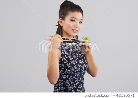 Sushi woman holding sushi with chopsticks 48150571