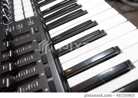 Black and white piano keys close up 48150903