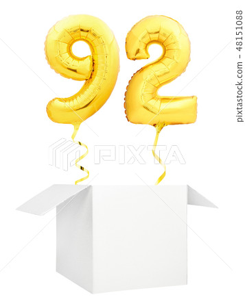 Golden number ninety two inflatable balloon with golden ribbon flying out of blank white box 48151088