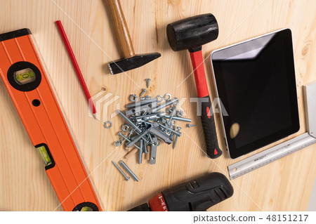 construction tool and a digital tablet lie on a light wooden table construction tool and a digital tablet lie on a light wooden table 48151217