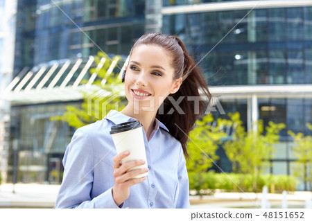 Happy young student with a coffee-to-go 48151652