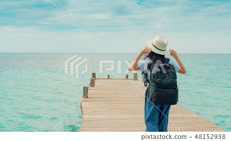 Happy young Asian woman on summer vacation at sea. 48152938